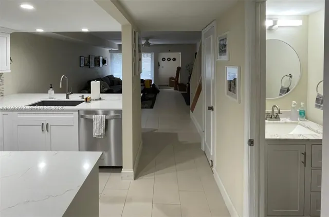 a view of a bathroom with a bathtub sink and mirror