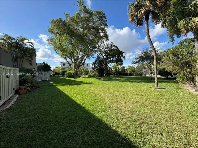 a city street with tall buildings in the background