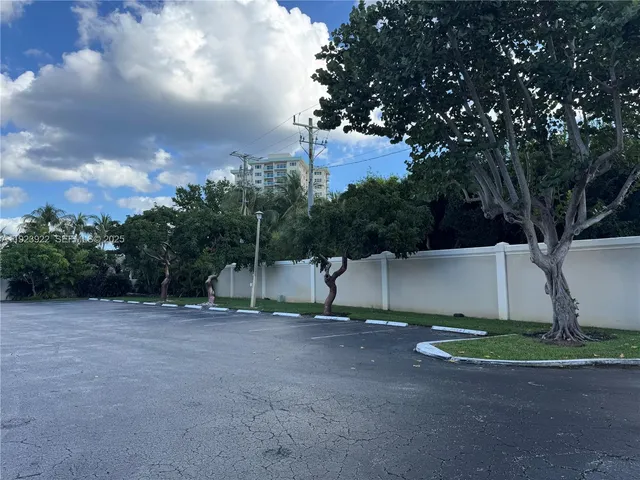 a view of a house with a yard and potted plants
