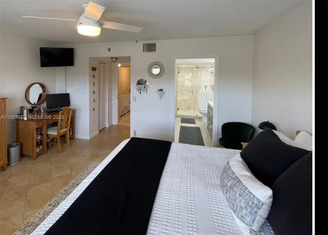 a bed room with a bed and a television