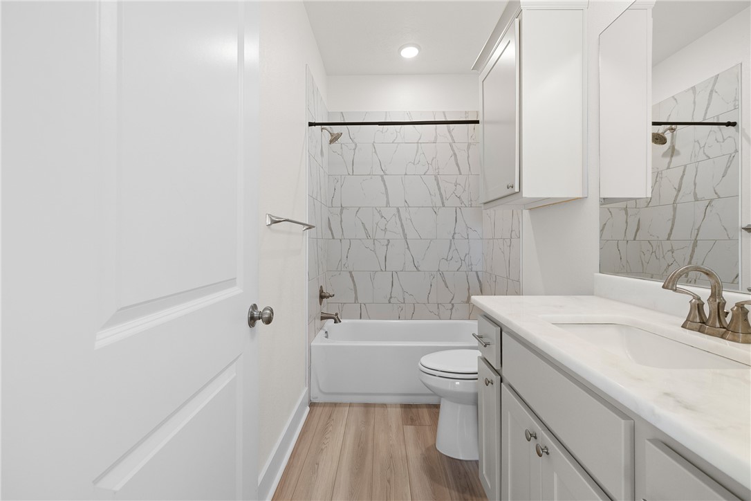 172 Pleasant Path Somerville, TX 77879 - Photo 7 of 13 a bathroom with a sink a toilet and shower