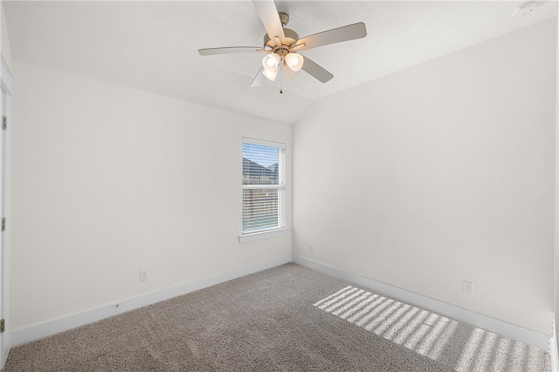 172 Pleasant Path Somerville, TX 77879 - Photo 10 of 13 an empty room with a window and a fan