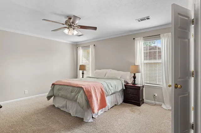 a spacious bedroom with a bed and a chandelier