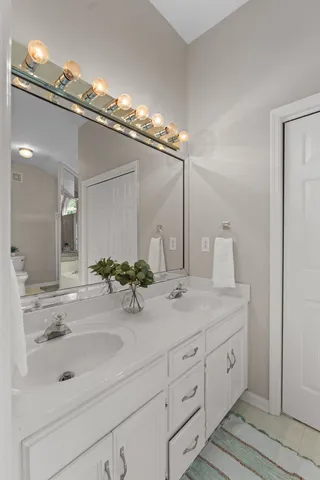 a bathroom with a sink double vanity and shower