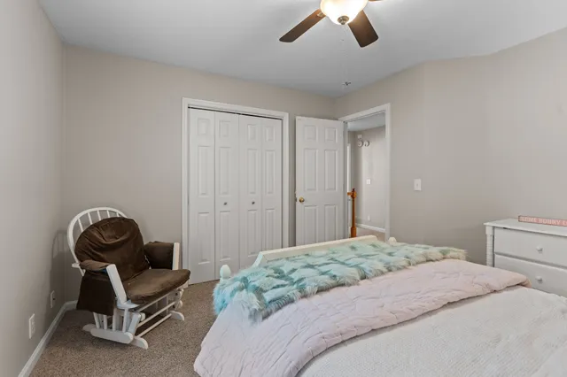 a bedroom with a bed and a chair