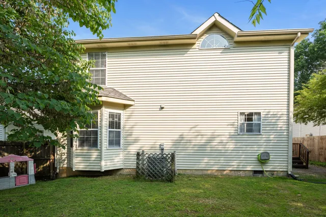 a view of a house with a backyard