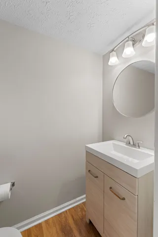 a bathroom with a sink vanity and a mirror