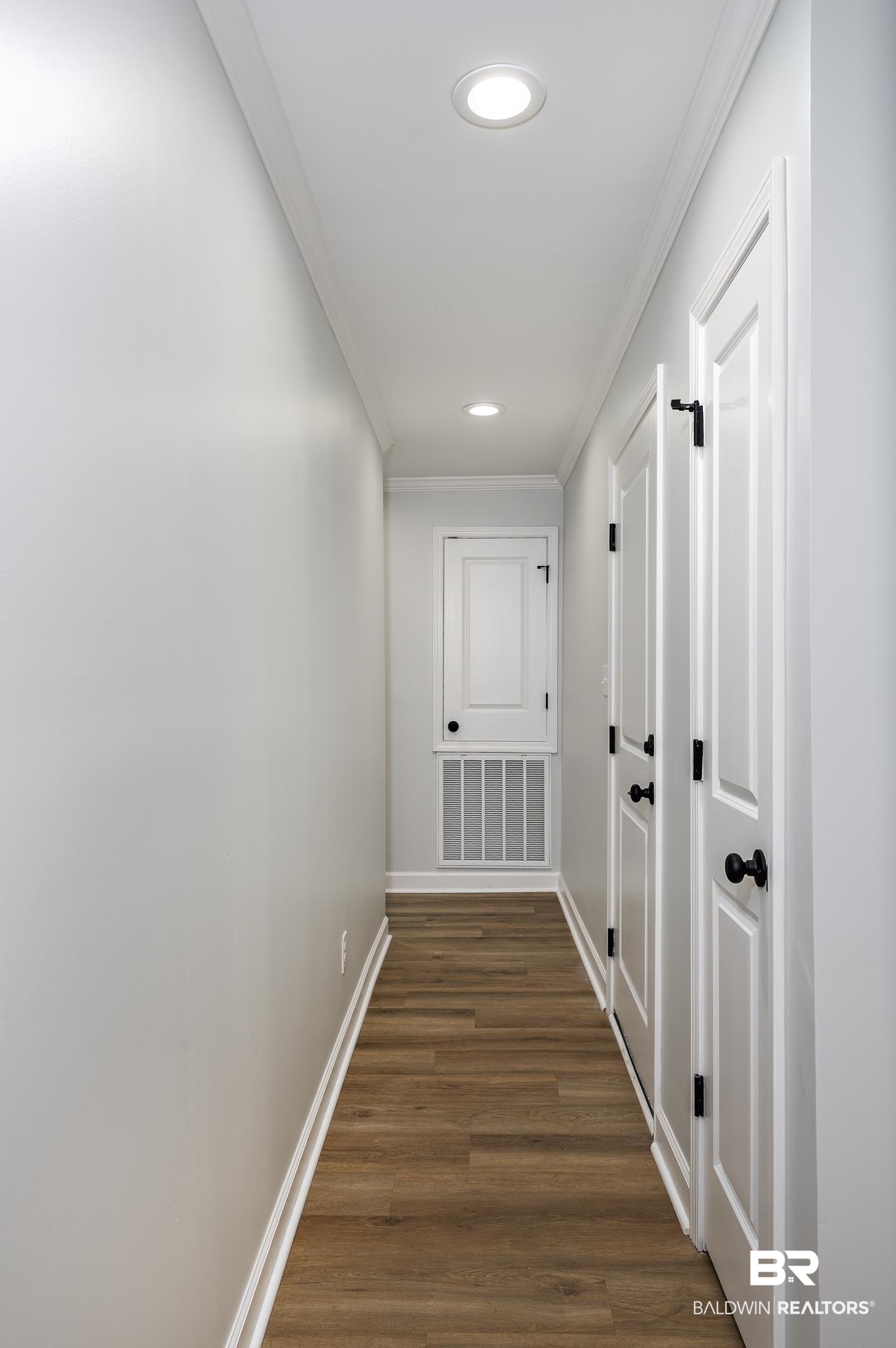 6001 Camp Halls Mill Road Mobile, AL 36619 - Photo 21 of 52 Hallway featuring dark wood finished floors, ornamental molding, and recessed lighting
