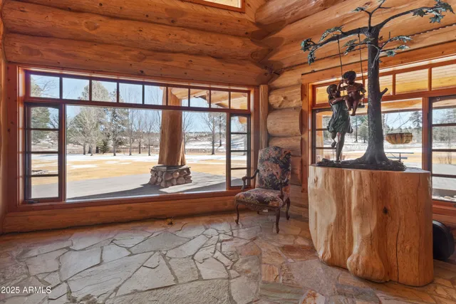 a bed sitting in a spacious bedroom next to a window