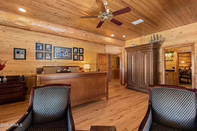 a view of an empty room with furniture and window