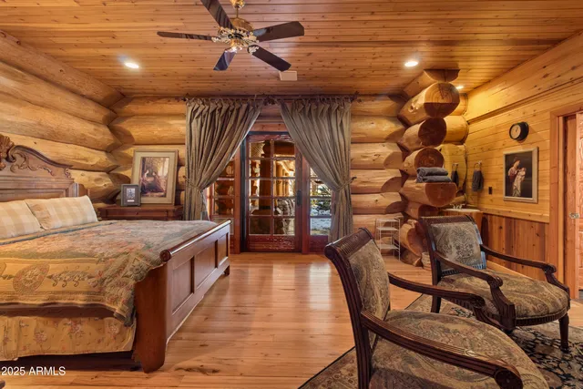 a bedroom with furniture and a flat screen tv