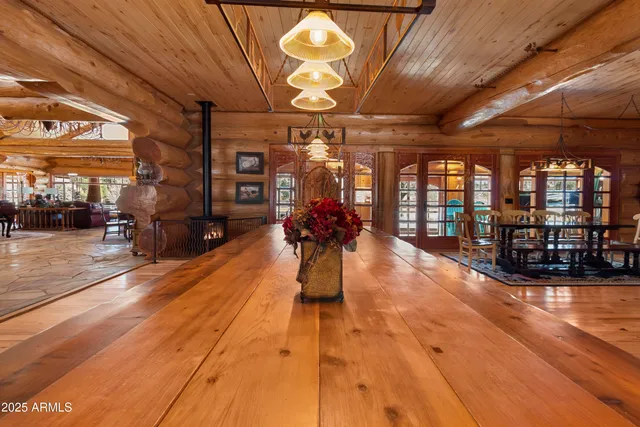a view of a swimming pool with lawn chairs and a big yard