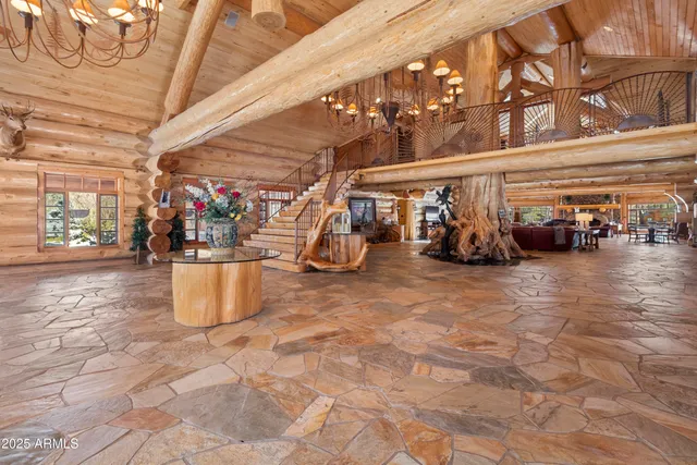 a living room with furniture a chandelier and a fireplace