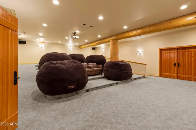 an aerial view of a house with a yard and trees all around