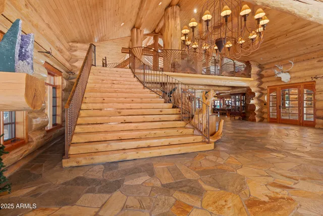 a living room with lots of furniture and a ceiling fan