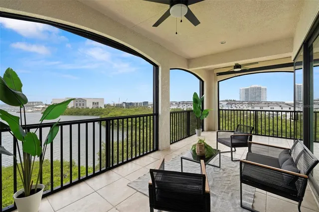 a kitchen with granite countertop a stove a sink dishwasher and white cabinets with wooden floor