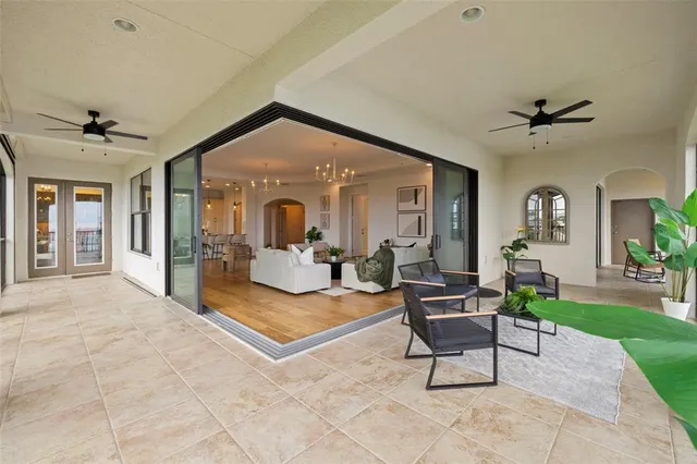 a large white kitchen with stainless steel appliances granite countertop a stove a sink dishwasher and white cabinets with wooden floor