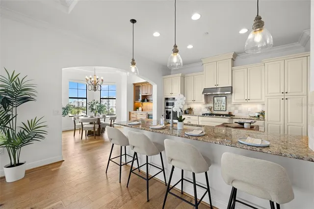 a view of a dining room with furniture a chandelier and wooden floor