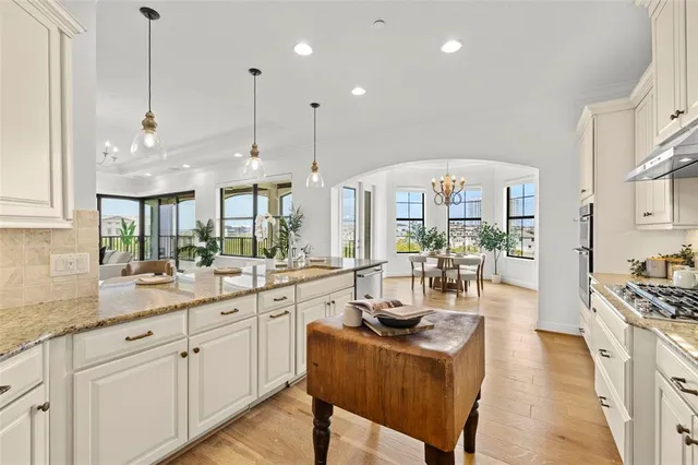 a view of a livingroom with a furniture wooden floor and a chandelier