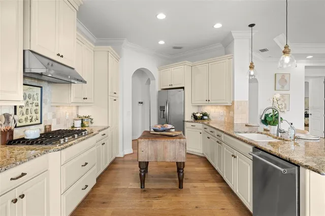 a bath tub sitting next to a white sink and a shower