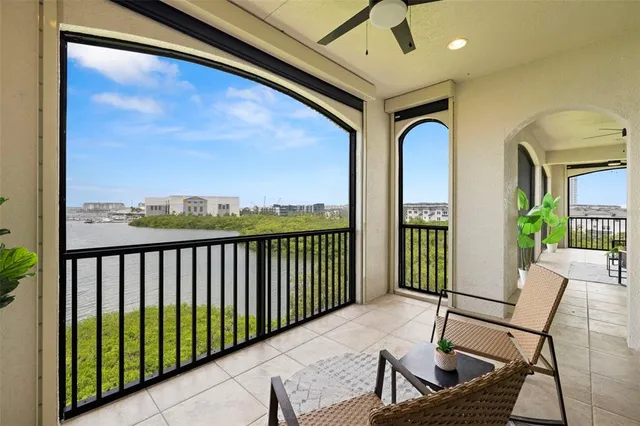 a living room with furniture large window and wooden floor