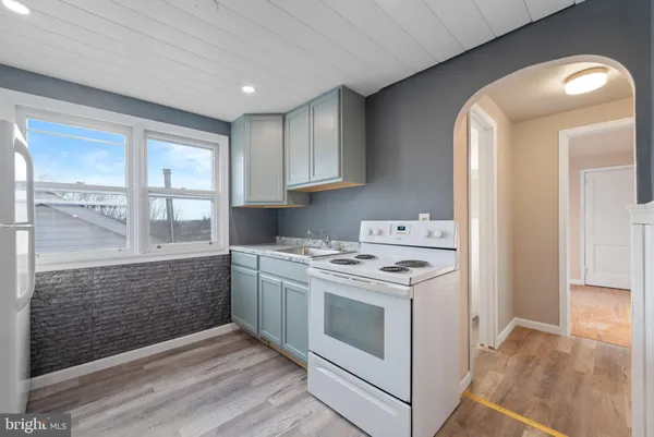 a kitchen with a stove top oven sink and cabinets