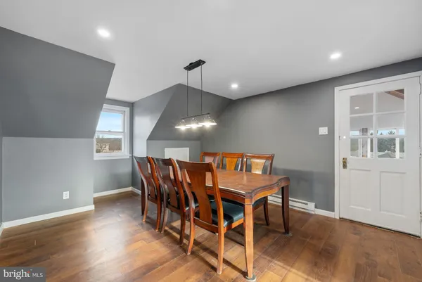 a view of a dining room with furniture and wooden floor