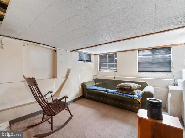 a living room with furniture a flat screen tv and a window
