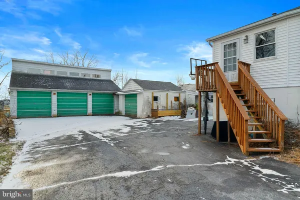 a view of a house with a yard and stairs