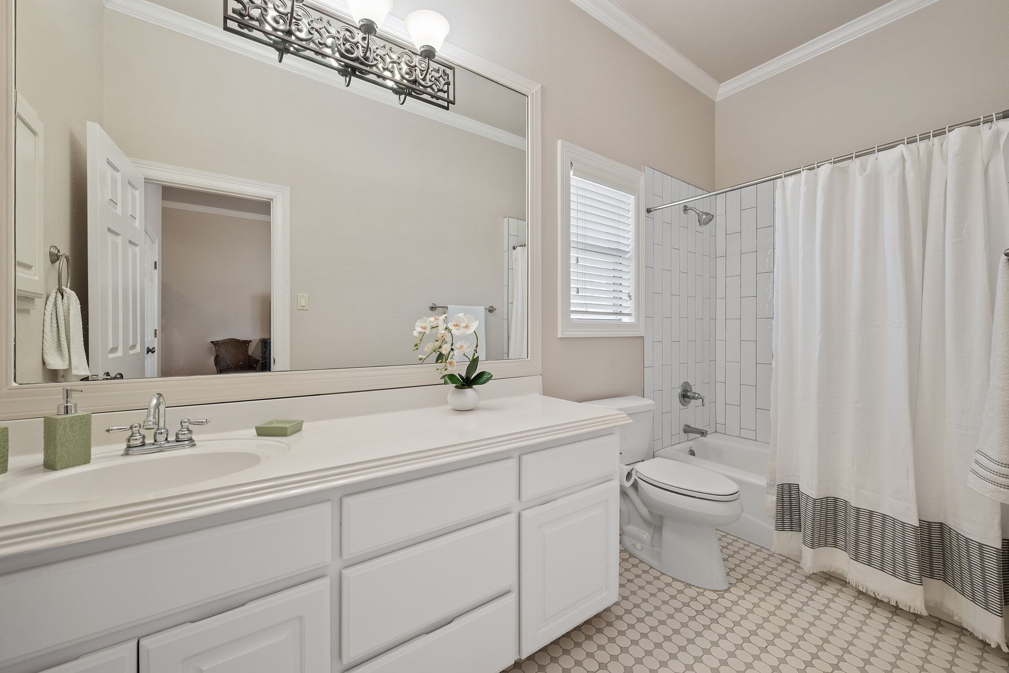 185 Shimmering Shore Court Spring Branch, TX 78070 - Photo 20 of 36 Bathroom with crown molding, vanity, and shower / bathtub combination with curtain