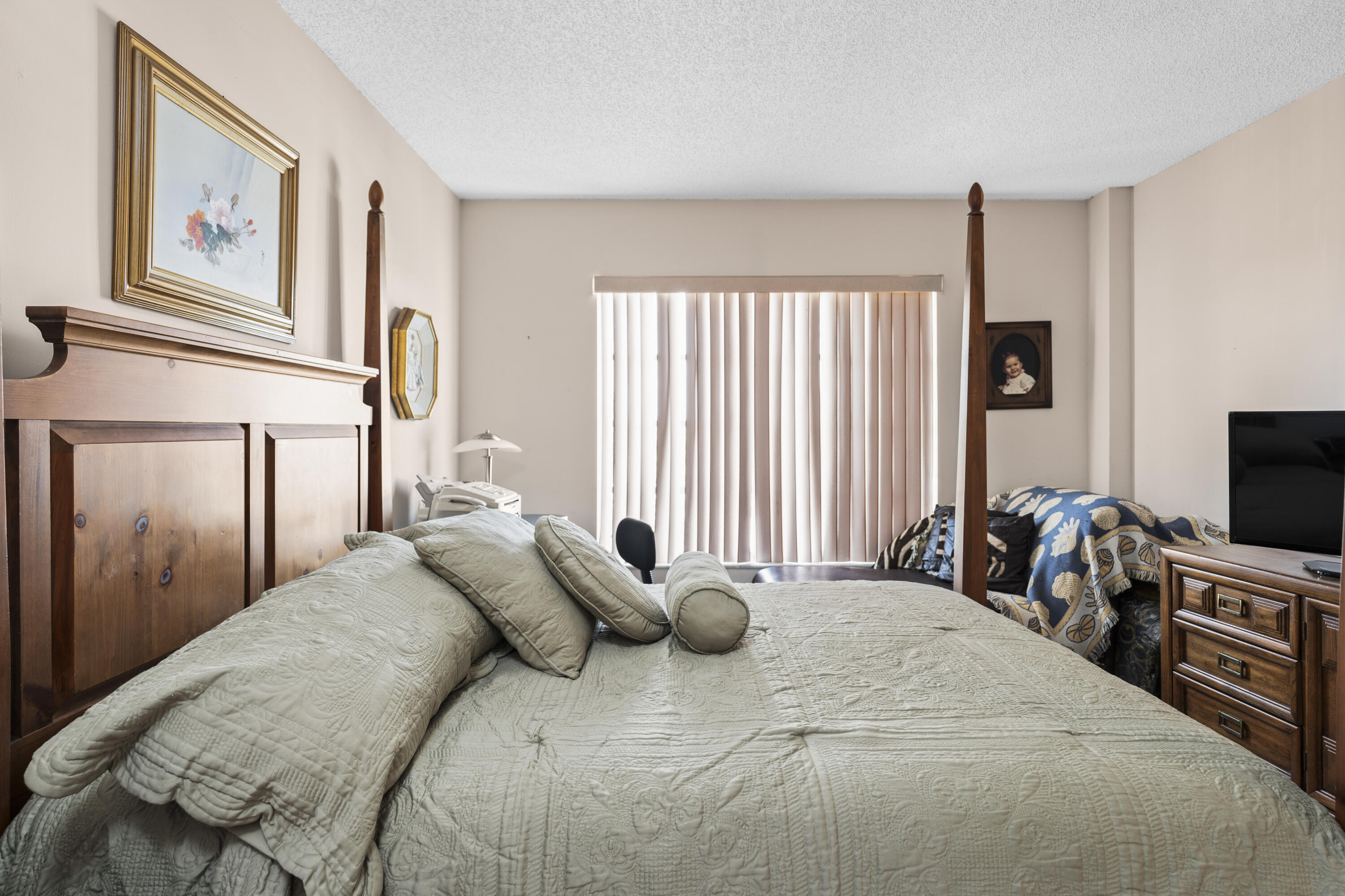 4174 Inverrary Drive, Unit 413 Lauderhill, FL 33319 - Photo 12 of 20 a bedroom with a bed and a flat screen tv