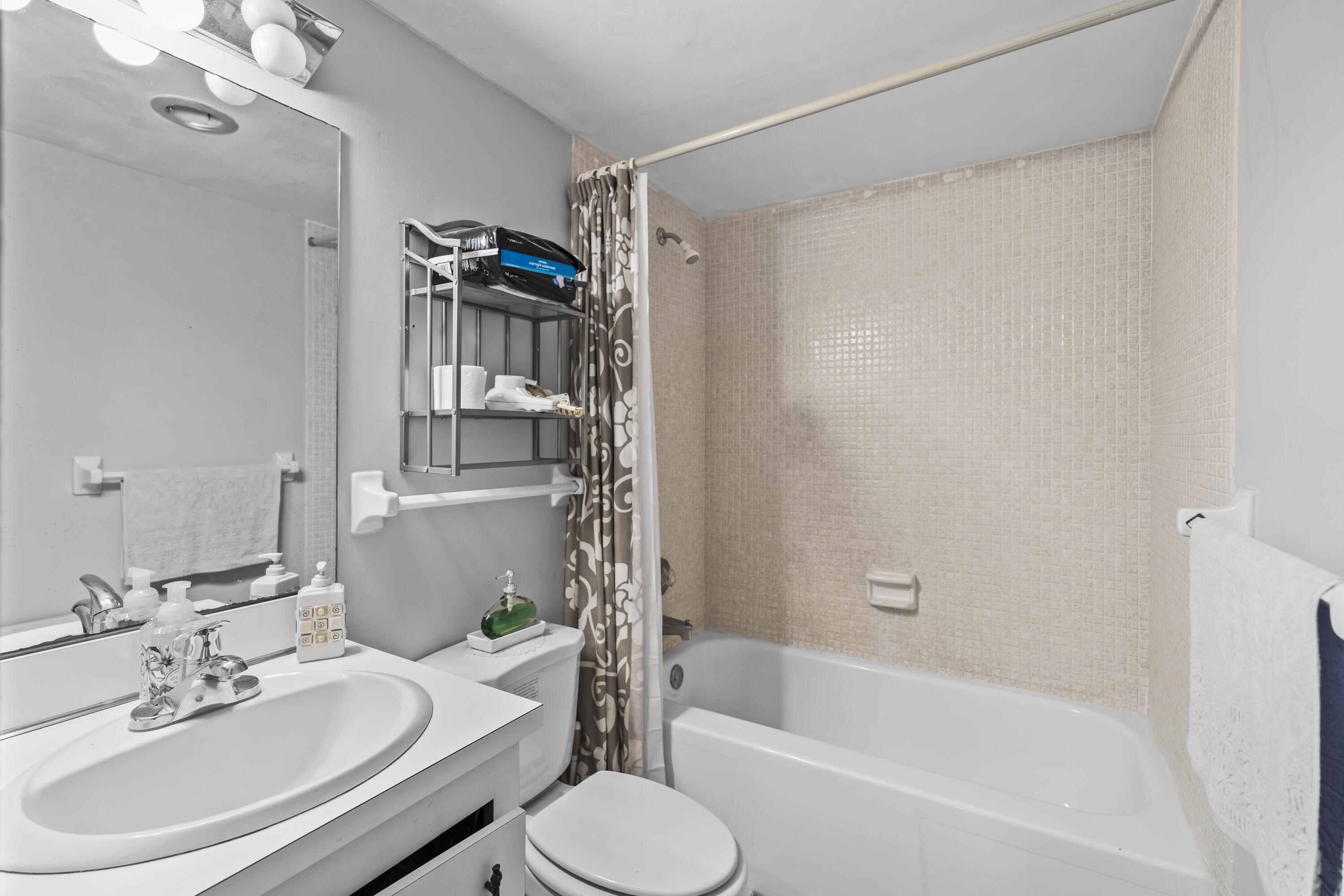 4174 Inverrary Drive, Unit 413 Lauderhill, FL 33319 - Photo 13 of 20 a bathroom with a sink toilet and shower