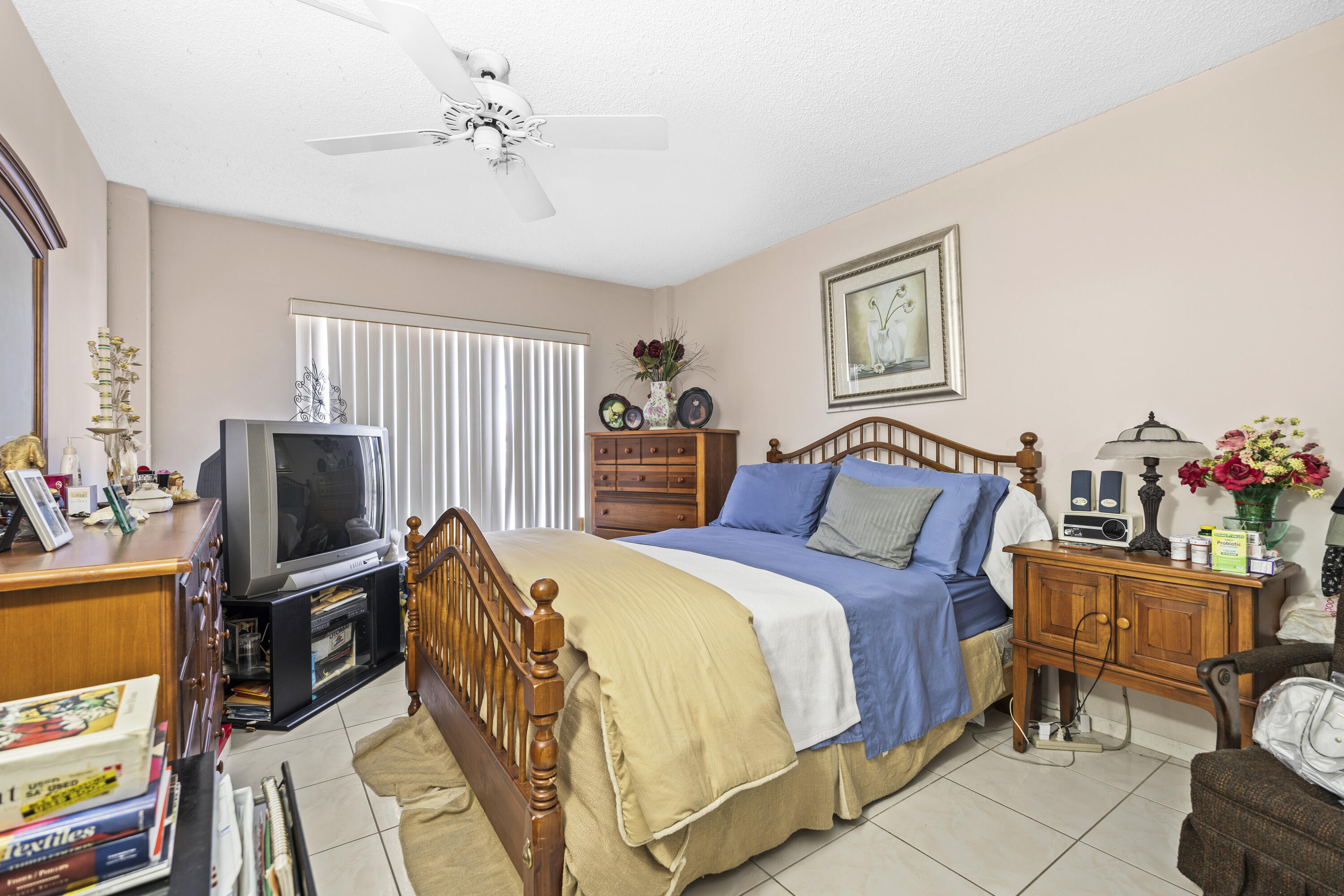 4174 Inverrary Drive, Unit 413 Lauderhill, FL 33319 - Photo 14 of 20 a bedroom with a bed and a flat screen tv