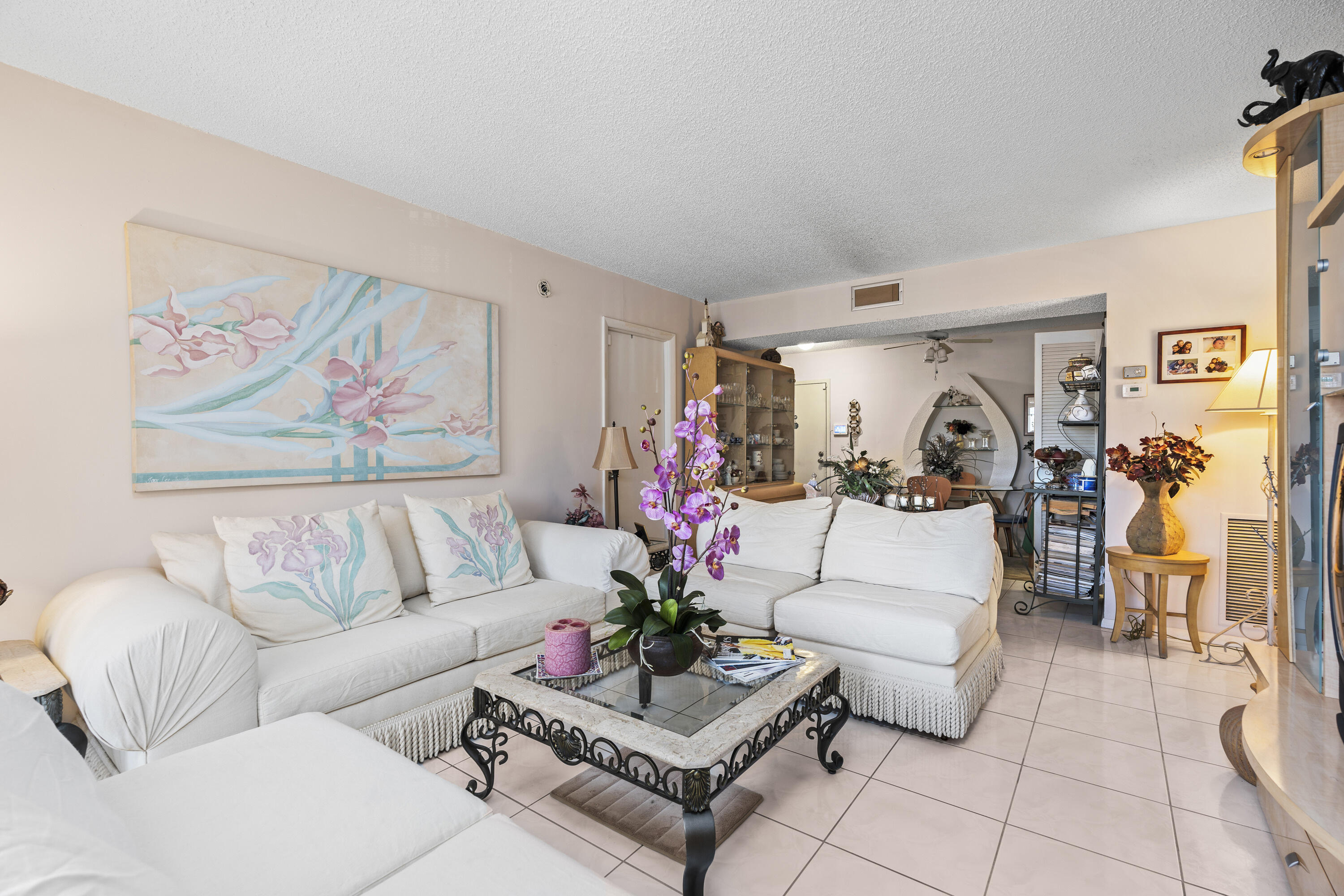 4174 Inverrary Drive, Unit 413 Lauderhill, FL 33319 - Photo 3 of 20 a living room with furniture and flowers