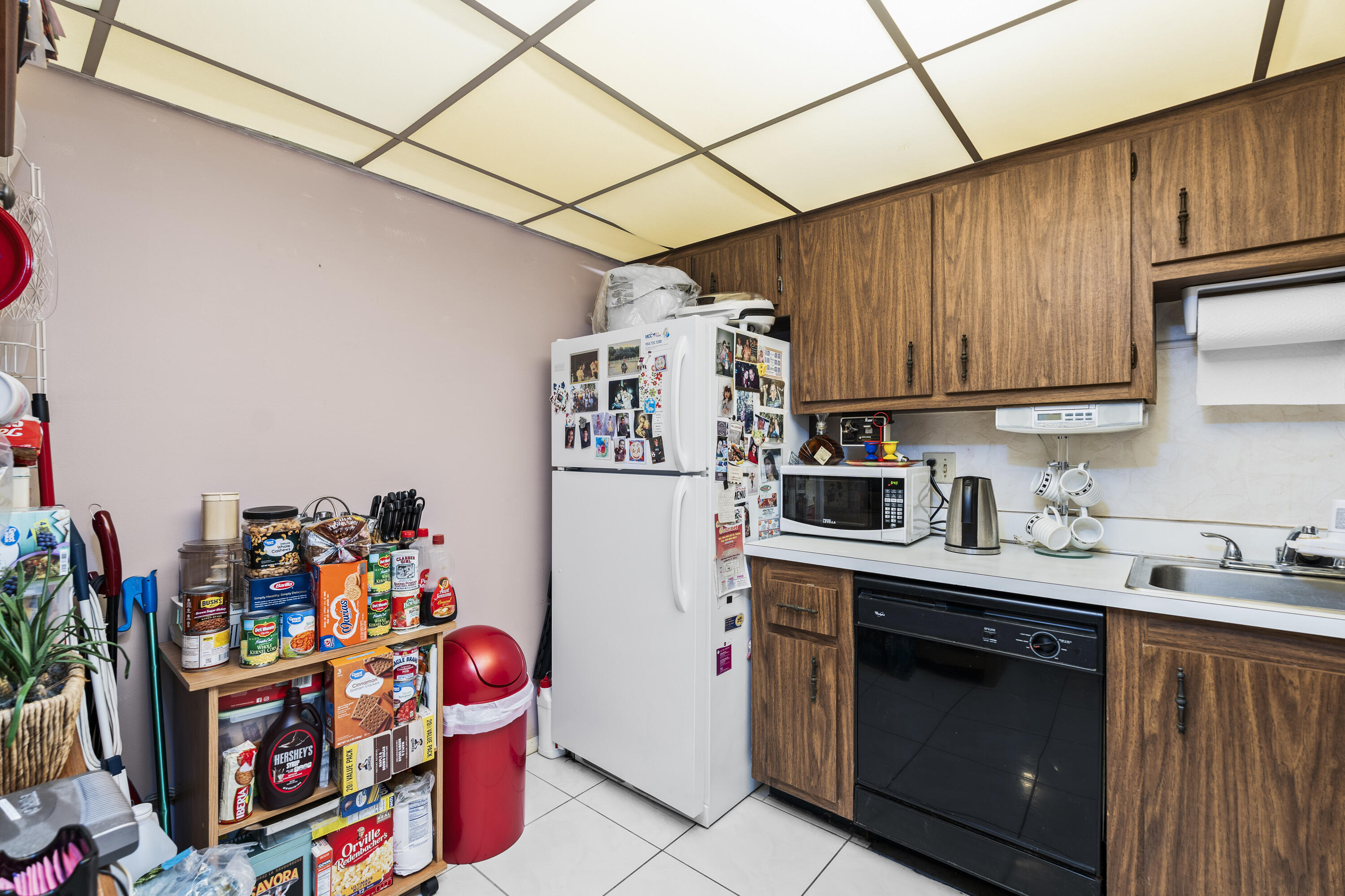 4174 Inverrary Drive, Unit 413 Lauderhill, FL 33319 - Photo 9 of 20 a kitchen with stainless steel appliances granite countertop a sink stove and refrigerator