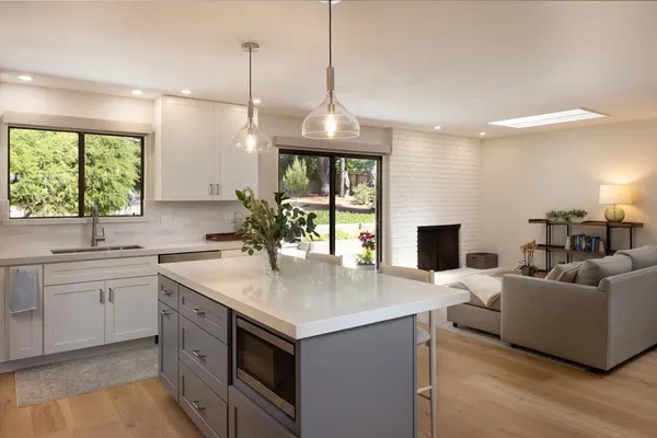 a kitchen with a stove a sink and a refrigerator