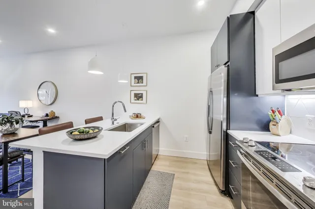 a kitchen with sink a stove and refrigerator