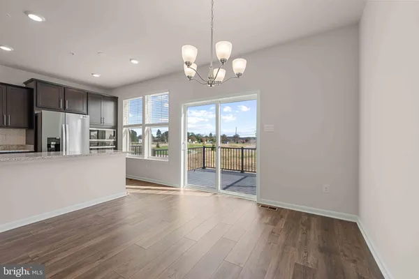 a view of kitchen with cabinets and wooden floor