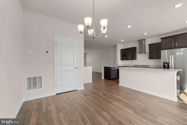 a view of a room with wooden floor and window