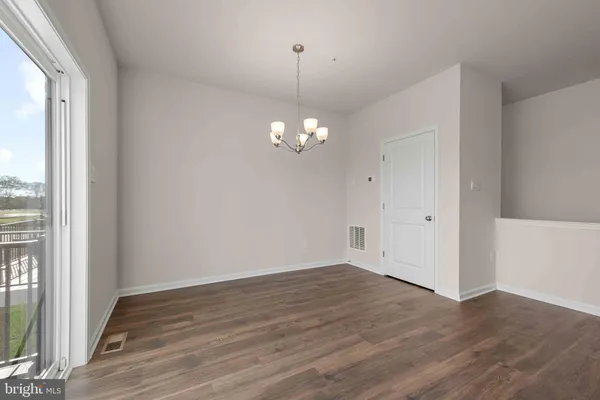 a large kitchen with stainless steel appliances a refrigerator and a stove top oven