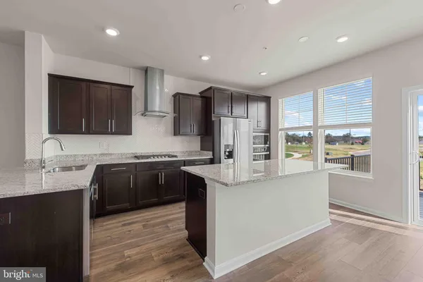 a kitchen with granite countertop a stove and a sink