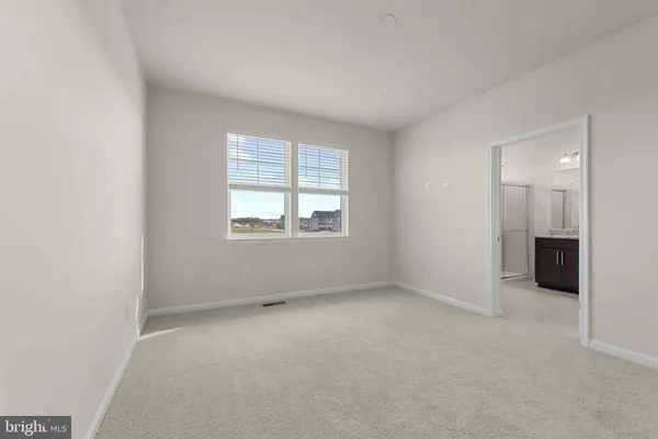 a bathroom with a granite countertop sink a mirror and shower