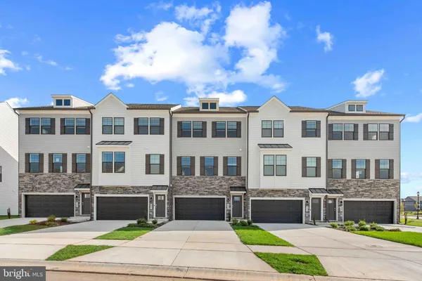 a front view of a building with a garden and entertaining space