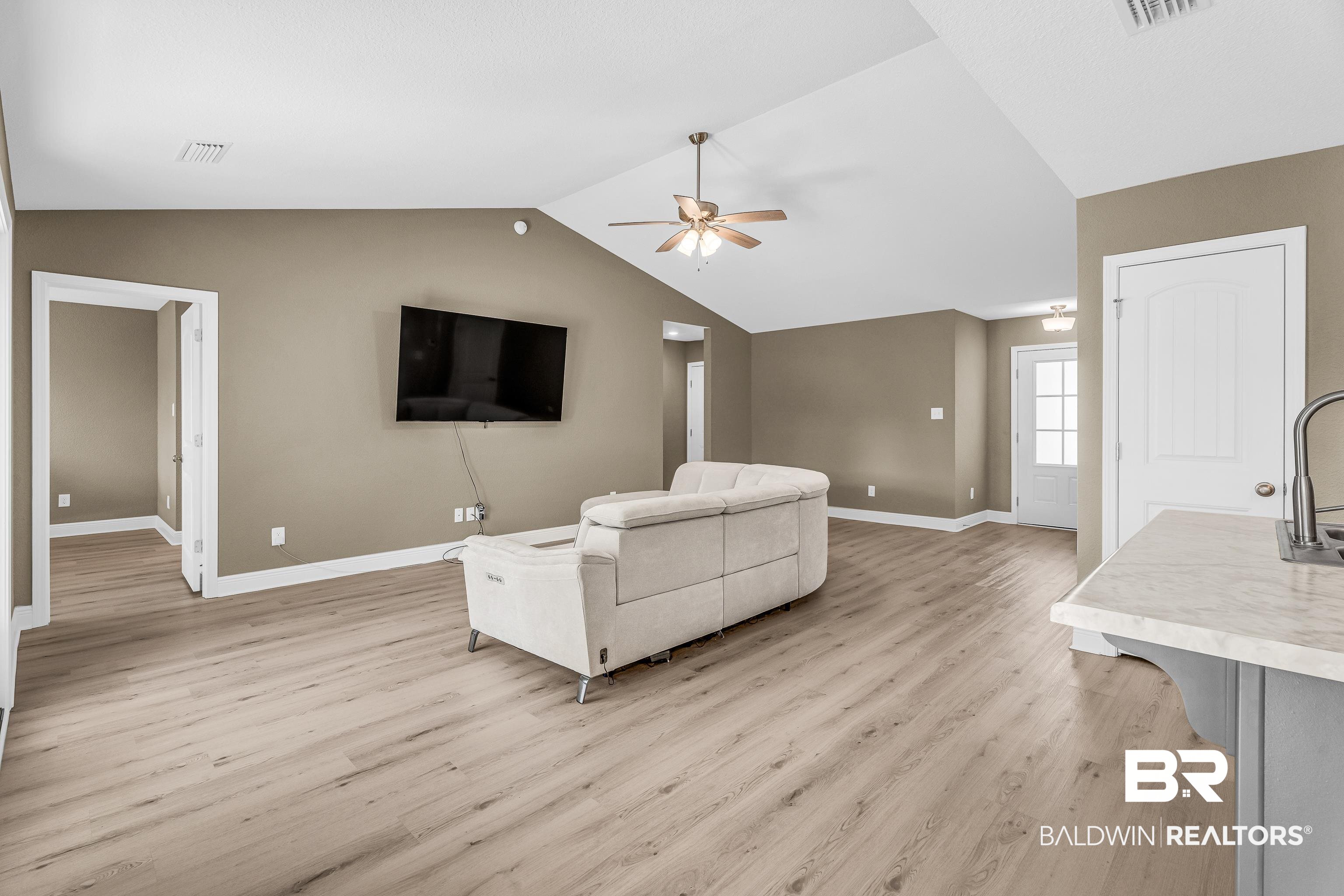 9206 Greenleaf Drive Daphne, AL 36527 - Photo 7 of 32 Living area with light wood-style flooring, lofted ceiling, and a ceiling fan