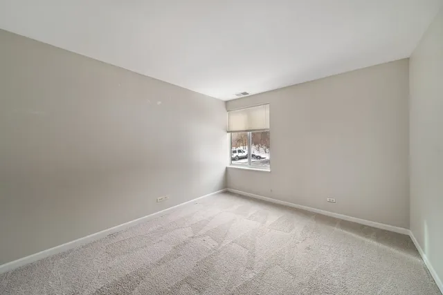 a view of an empty room and a window