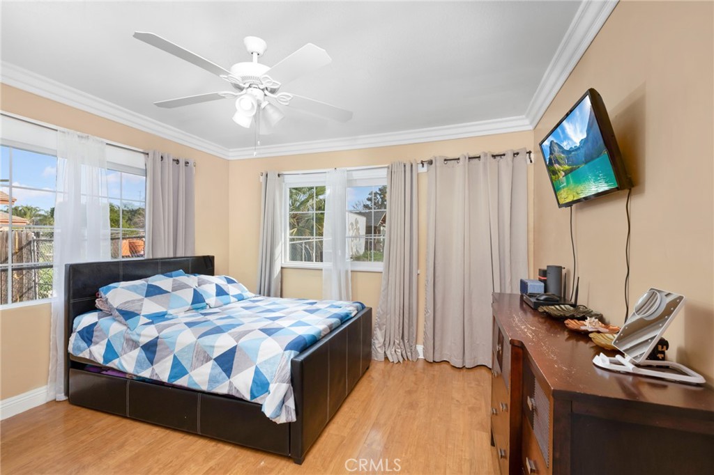 1816 Main Street Riverside, CA 92501 - Photo 15 of 34 a bedroom with a bed and a chandelier