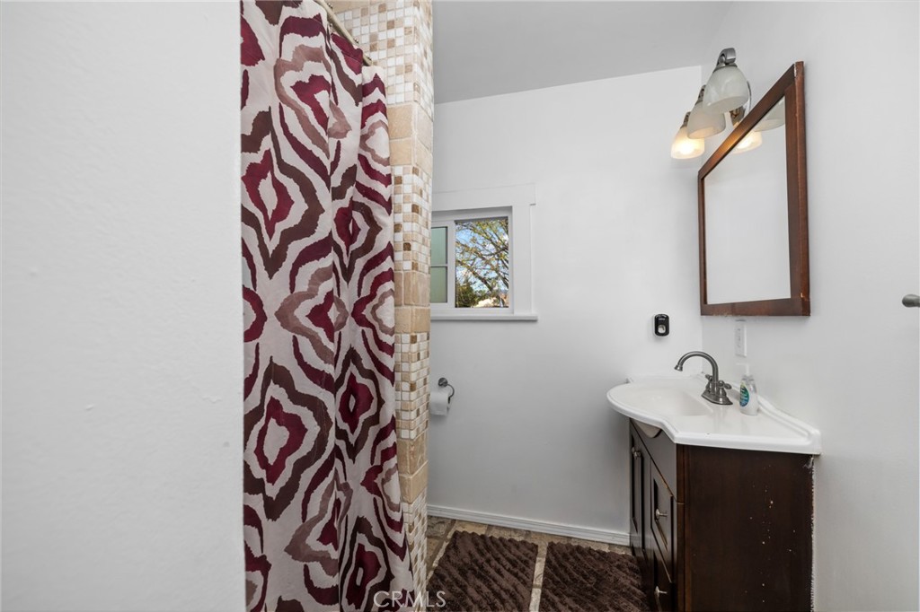 1816 Main Street Riverside, CA 92501 - Photo 17 of 34 a bathroom with a sink and a mirror