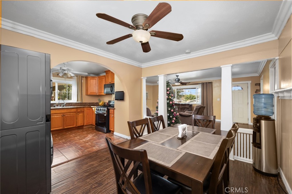 1816 Main Street Riverside, CA 92501 - Photo 8 of 34 a dining room with stainless steel appliances kitchen island granite countertop furniture and wooden floor