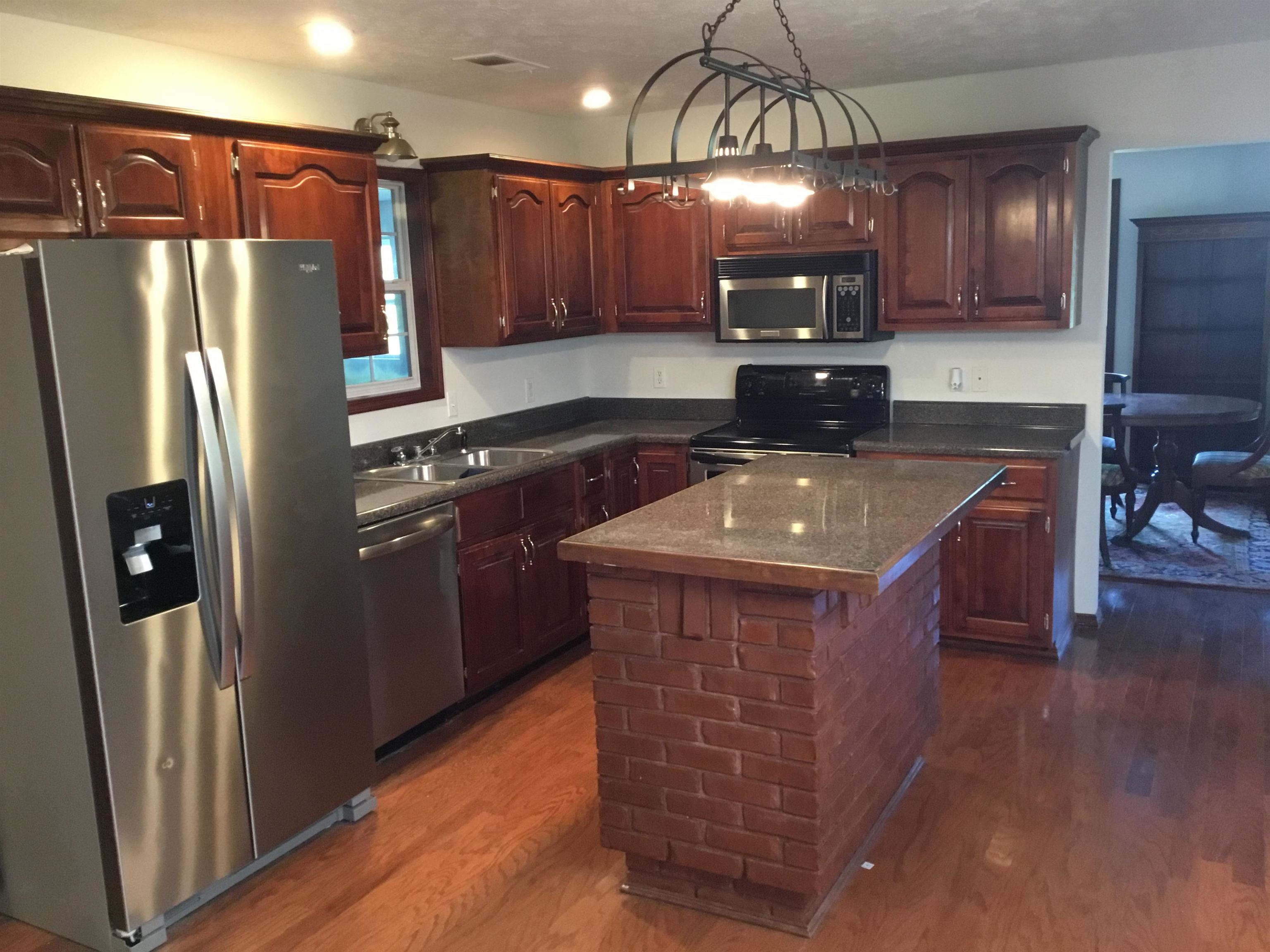 2695 Central Curve Road Ripley, TN 38063 - Photo 14 of 32 a kitchen with stainless steel appliances granite countertop a stove a refrigerator a sink and dishwasher