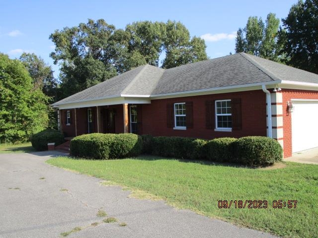 2695 Central Curve Road Ripley, TN 38063 - Photo 2 of 32 a view of a brick house with a yard plants and large tree